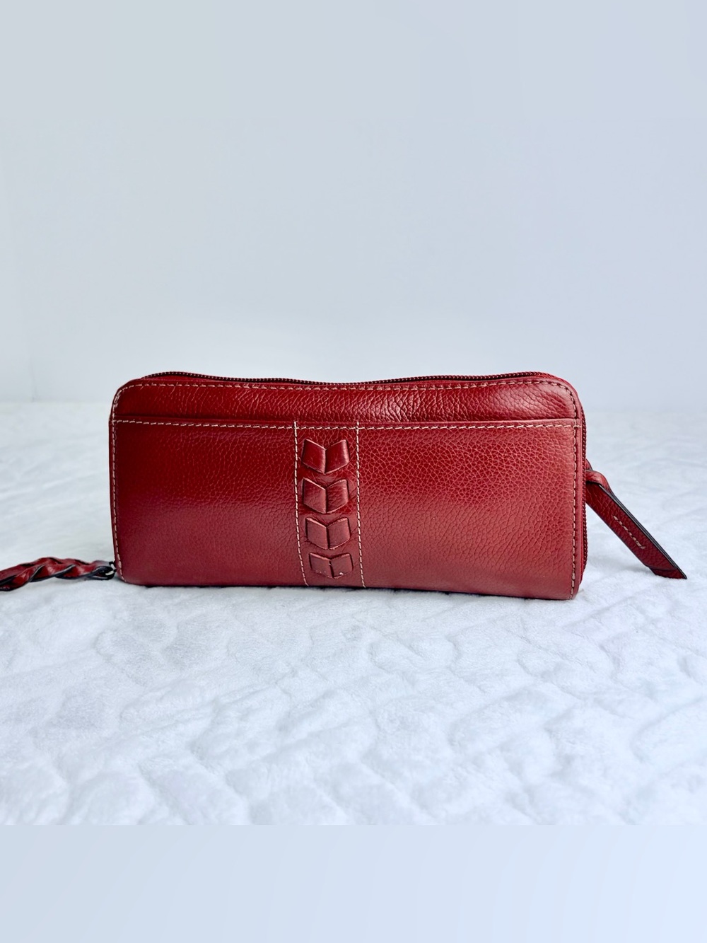 Retro style Tignanello oxblood red leather wallet with decorative stitching